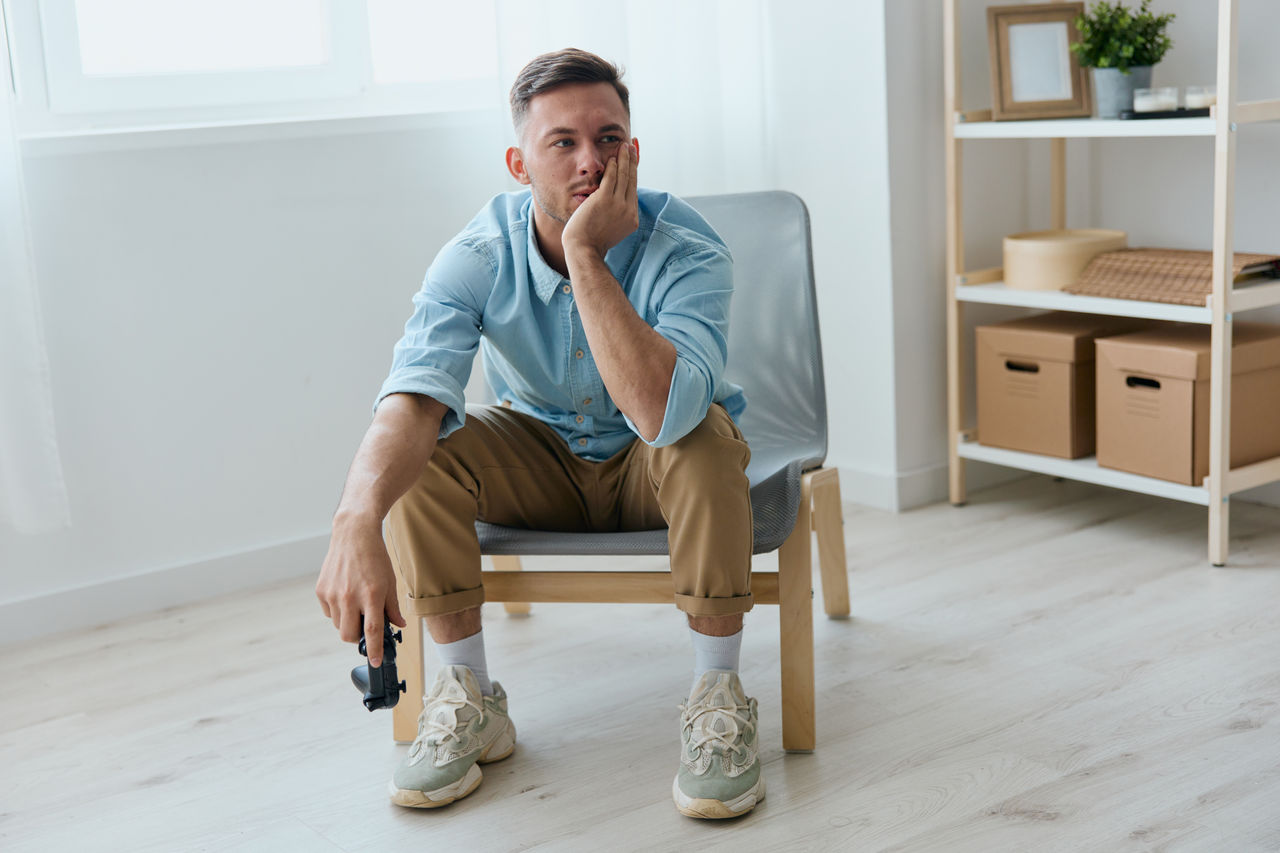 portrait of young man sitting on chair