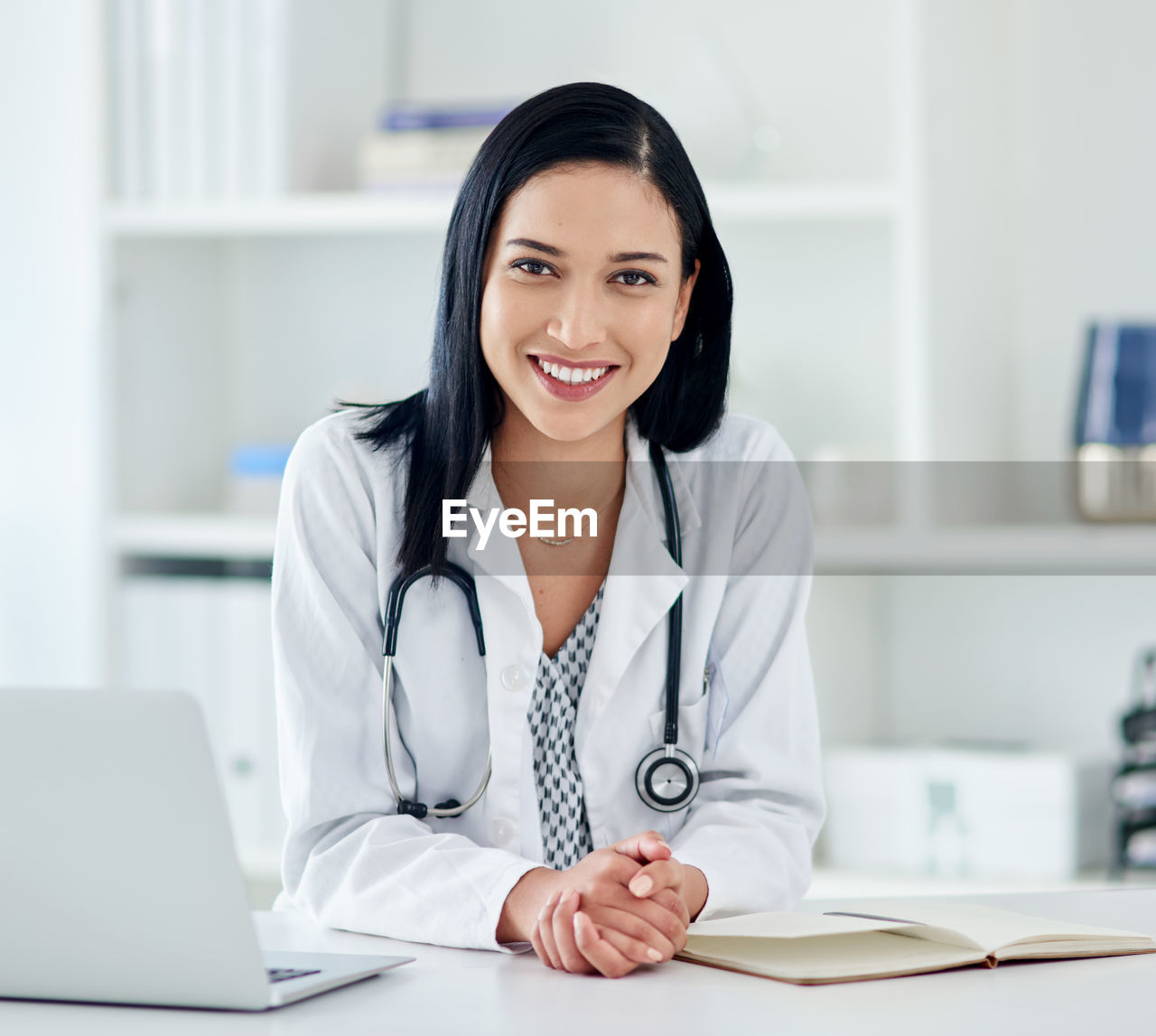 Portrait of young businesswoman working at desk in office