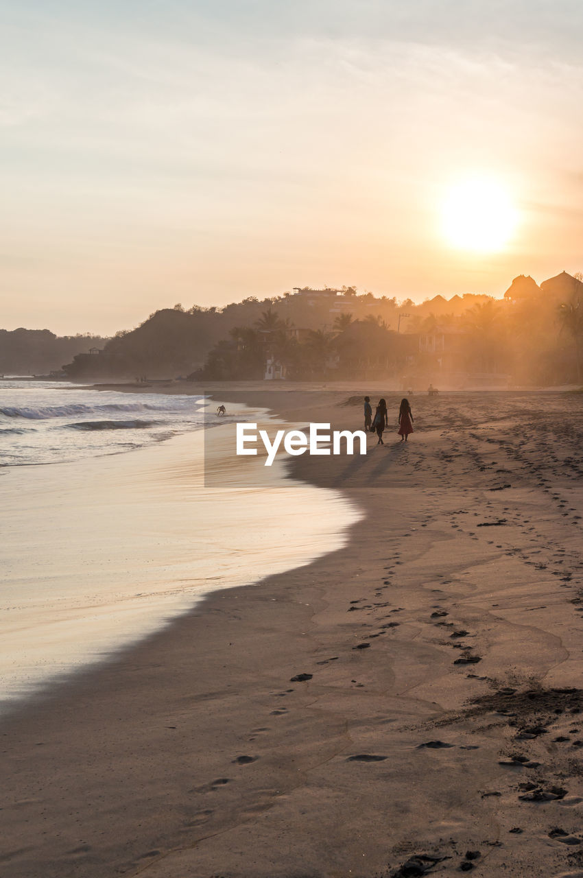 PEOPLE AT BEACH DURING SUNSET