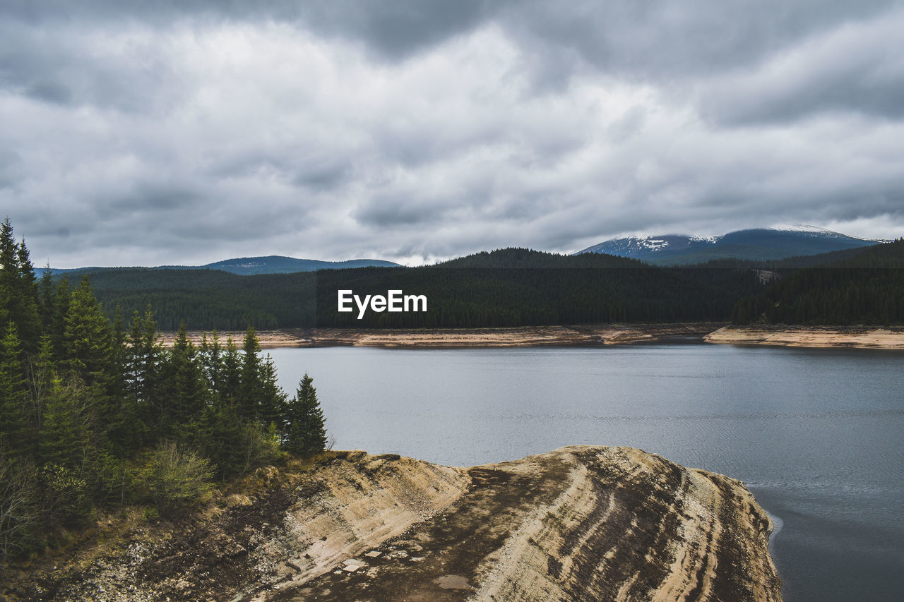 Scenic view of lake and mountains against sky