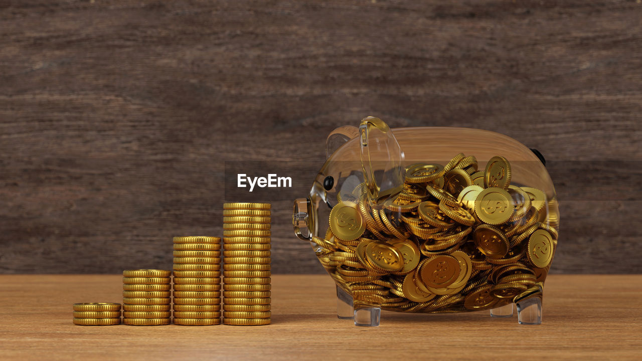 finance, coin, savings, yellow, wealth, investment, currency, business, gold, money, metal, wood, success, indoors, business finance and industry, large group of objects, table, no people, banking, abundance, finance and economy, achievement