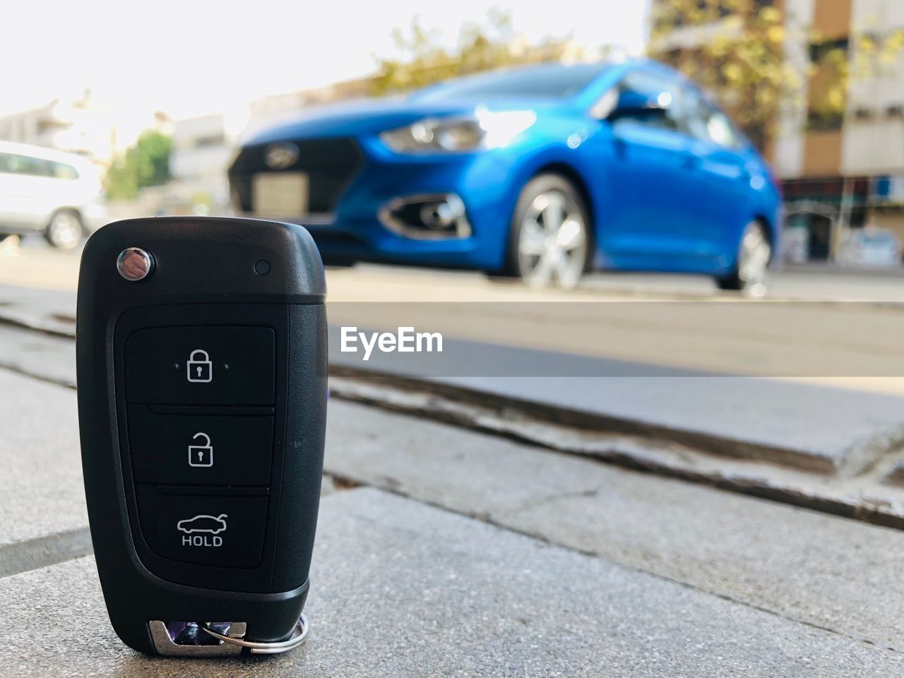 Close-up of car key on road