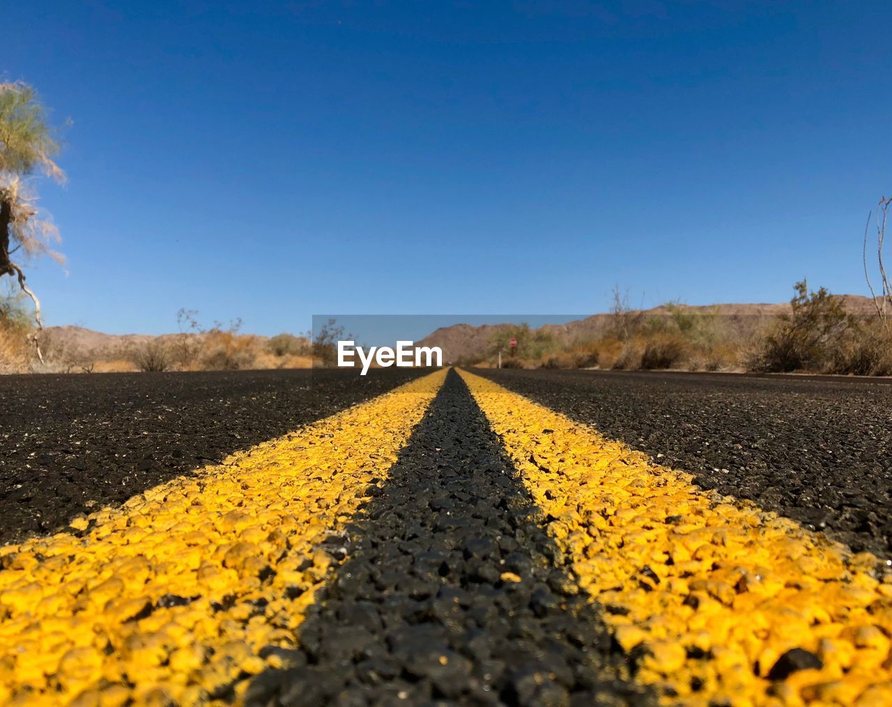 SURFACE LEVEL OF ROAD AGAINST CLEAR SKY