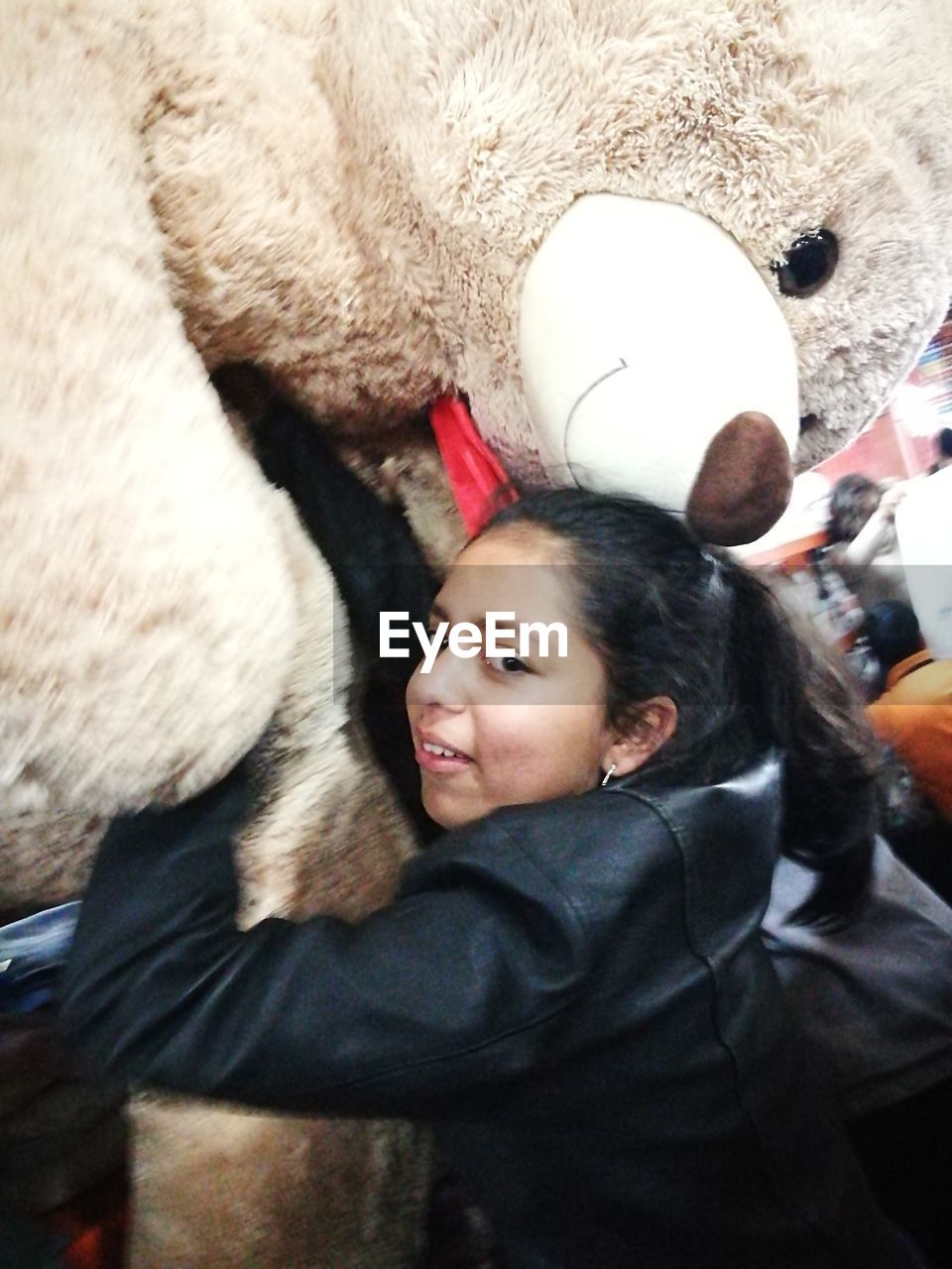 Close-up of girl hugging teddy bear