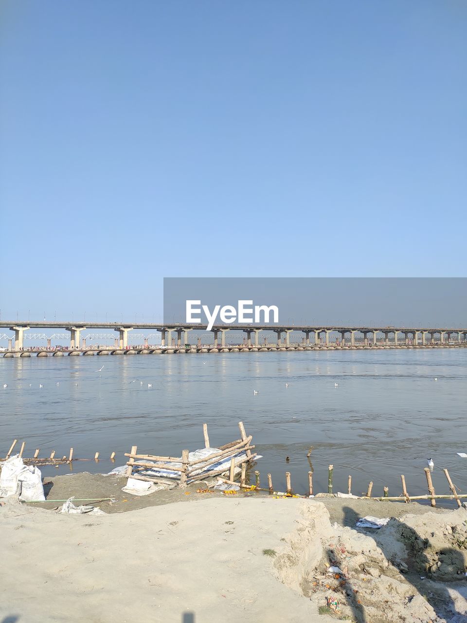 Scenic view of beach against clear blue sky