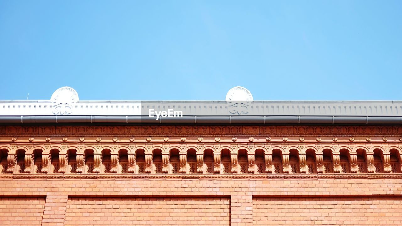 High section of building against blue sky