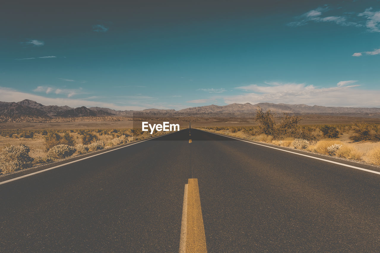 Empty road along desert landscape