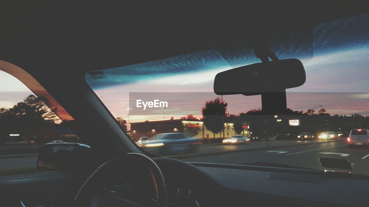 Car on road against sky during sunset