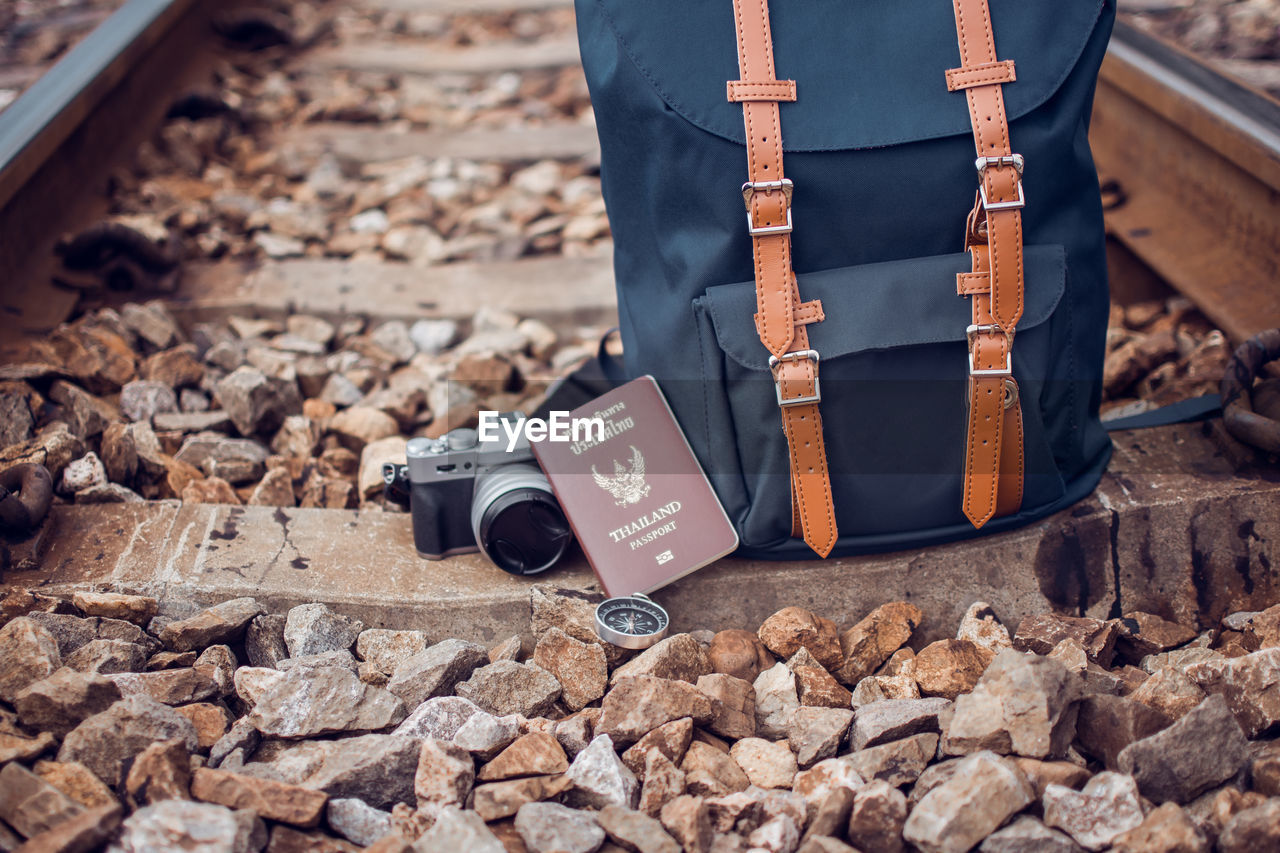 Backpack with camera and passport on railroad tie