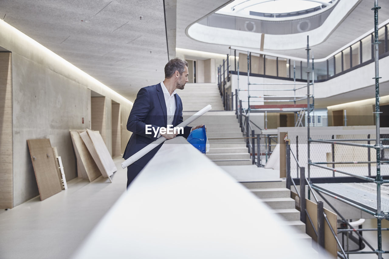 Architect in office building looking around