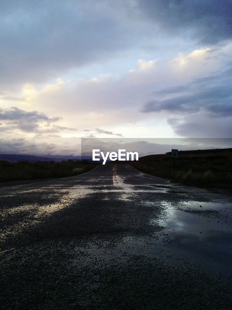 VIEW OF LAKE AGAINST CLOUDY SKY