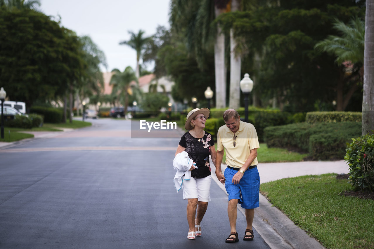 Senior couple walking hand in hand enjoying retirement