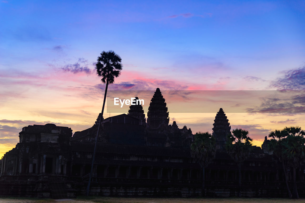 SILHOUETTE OF TEMPLE AGAINST SKY AT SUNSET