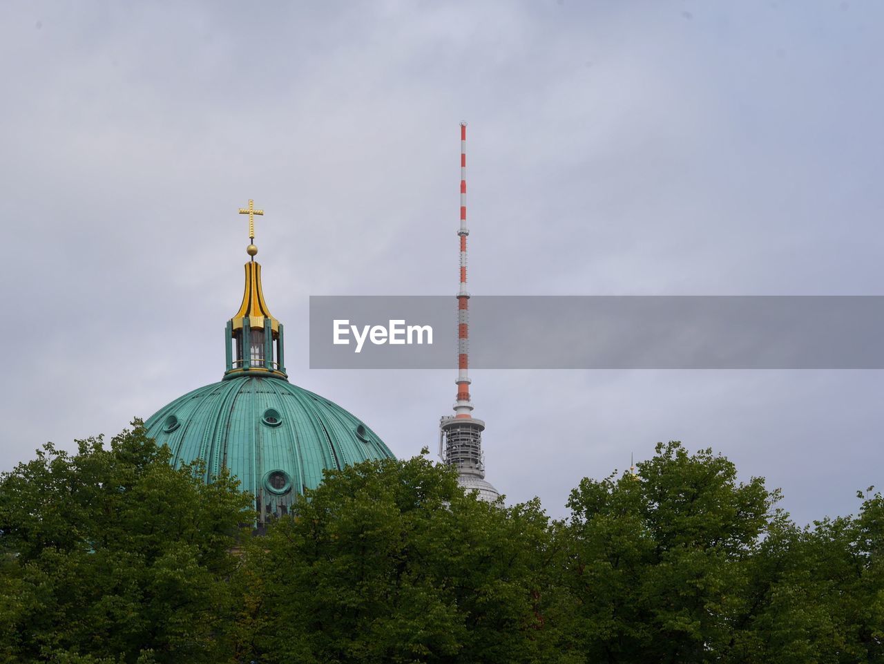 Low angle view of the berlin dome and the fernsehturm against the sky