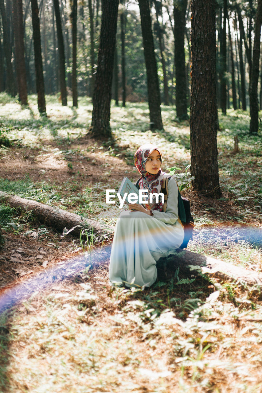 YOUNG WOMAN IN FOREST