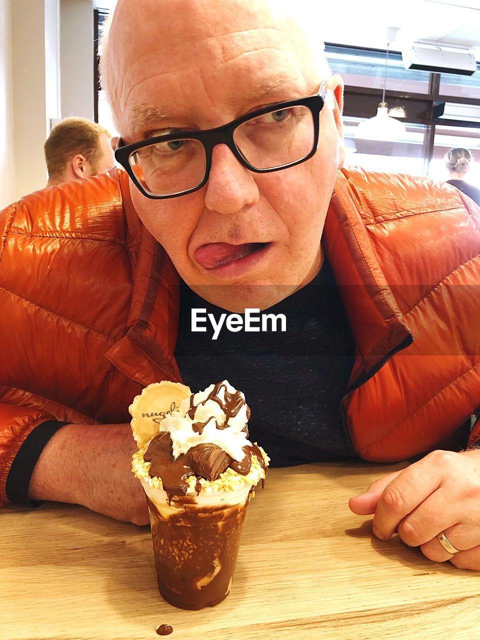 PORTRAIT OF MAN WITH ICE CREAM IN GLASSES
