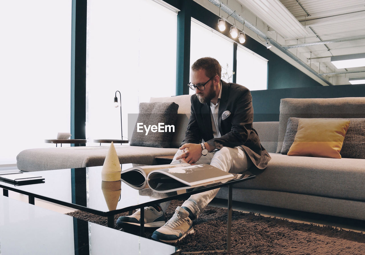 Young businessman sitting on sofa in office