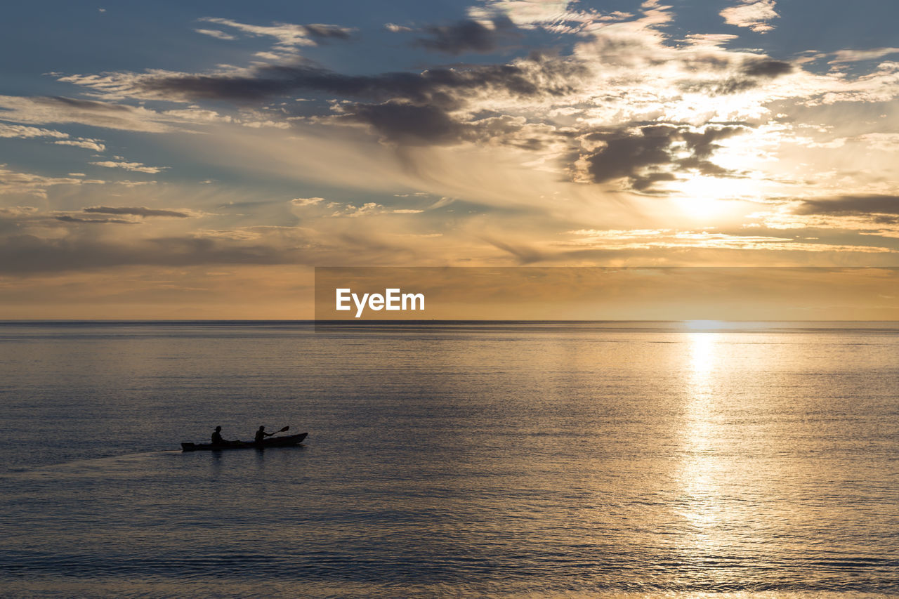 scenic view of sea against dramatic sky during sunset