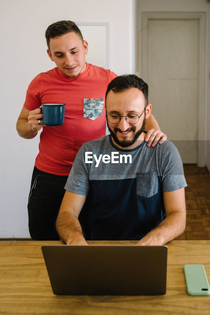 Two men looking at a laptop.