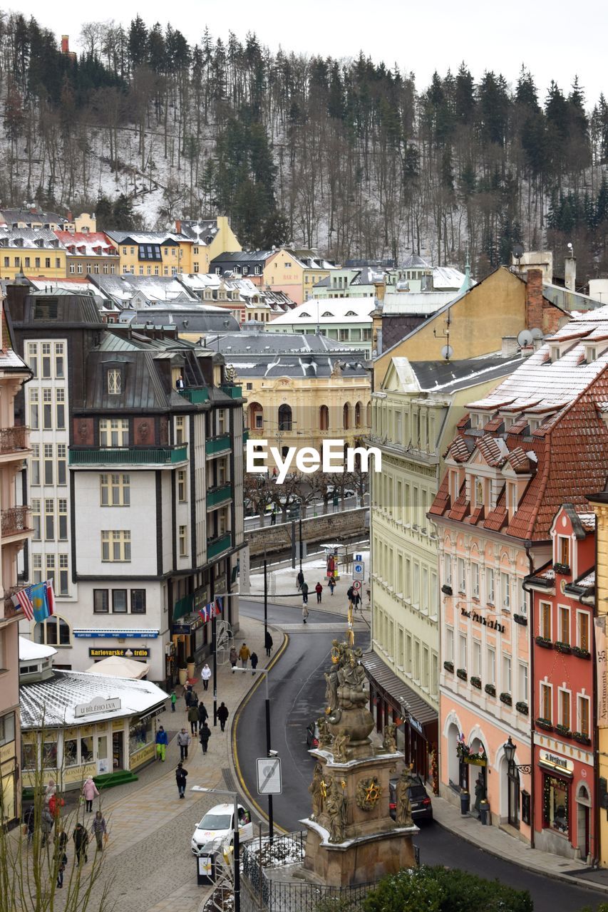 HIGH ANGLE VIEW OF STREET AMIDST BUILDINGS