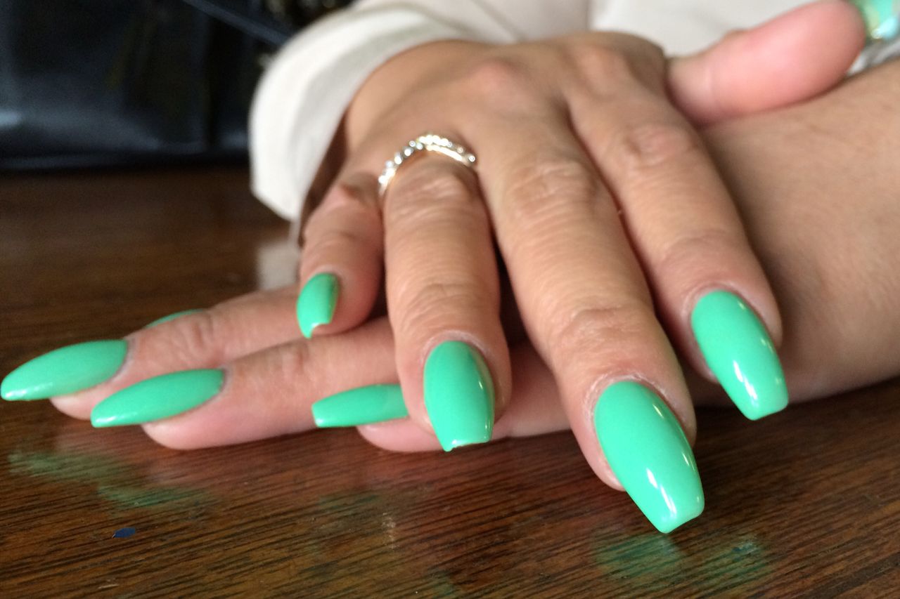 Close-up of womans fingers with painted nails