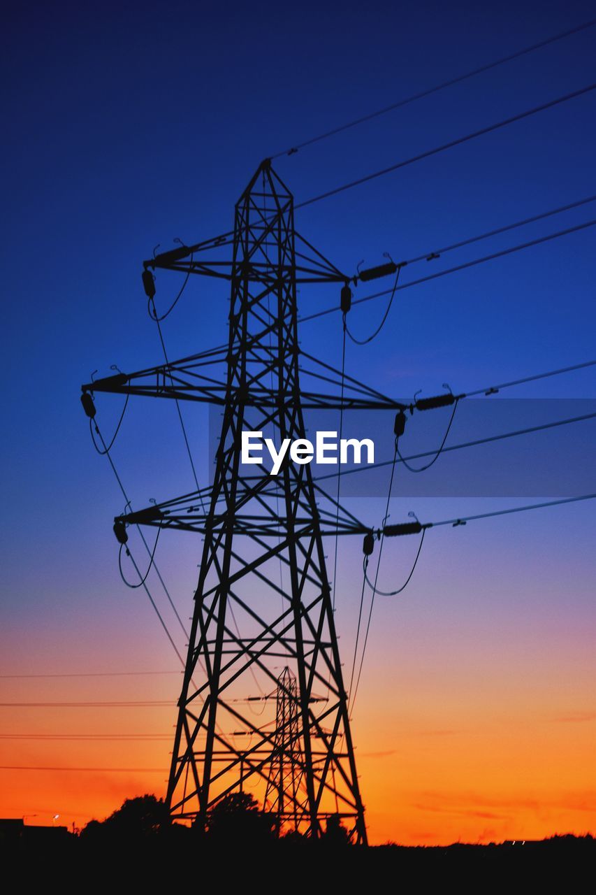 LOW ANGLE VIEW OF SILHOUETTE ELECTRICITY PYLON AGAINST SKY