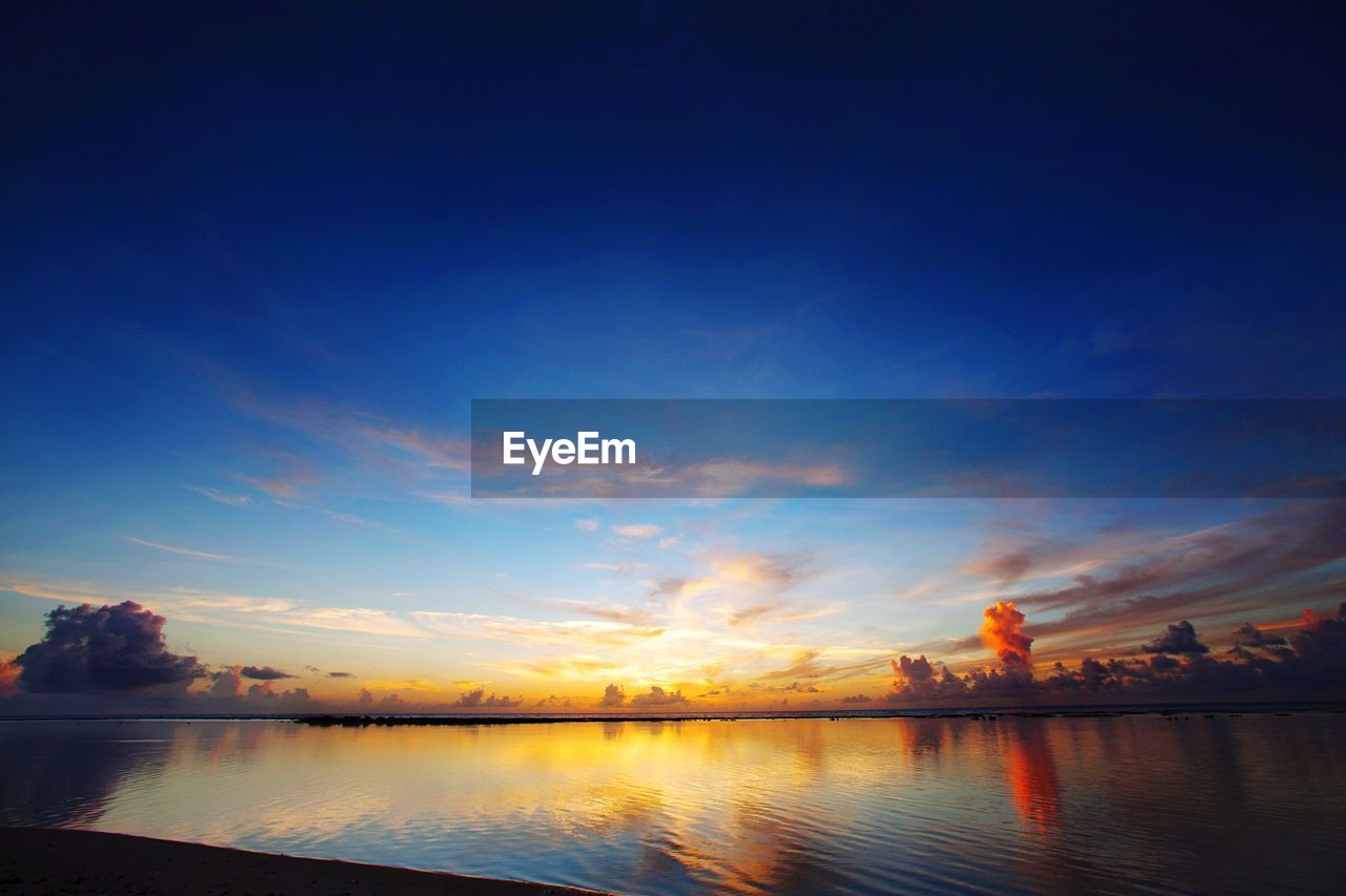 Scenic view of lake against sky during sunset