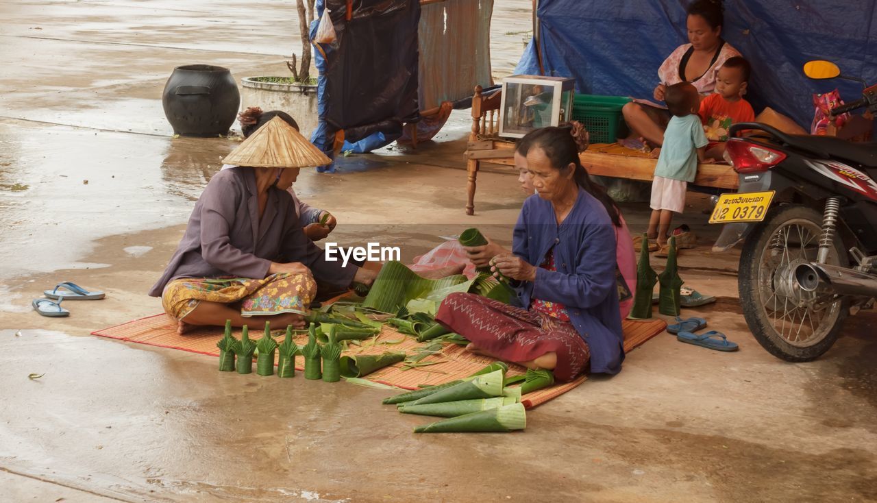 PEOPLE WORKING ON MARKET STALL