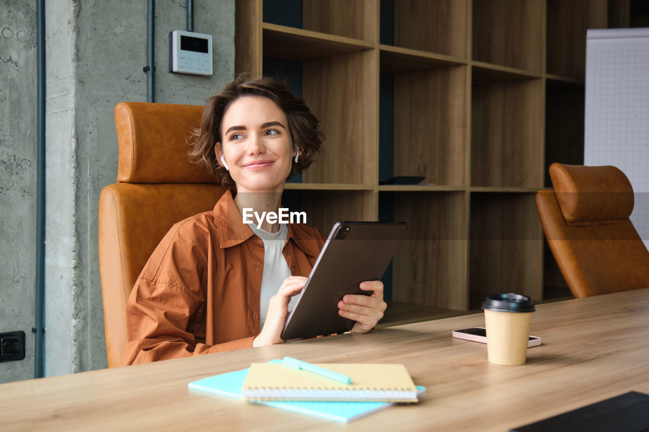 young woman using laptop at desk