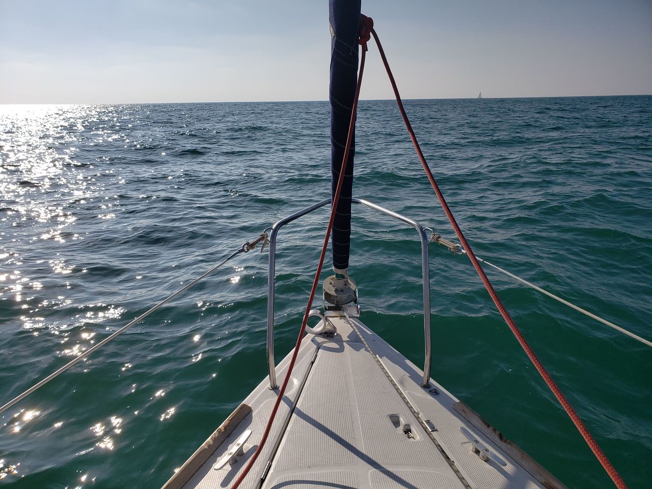 Sailboat sailing on sea against sky