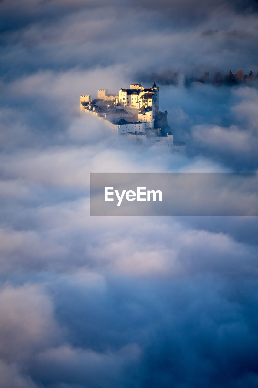 Fortress hohensalzburg rising above a sea of clouds, salzburg, austria