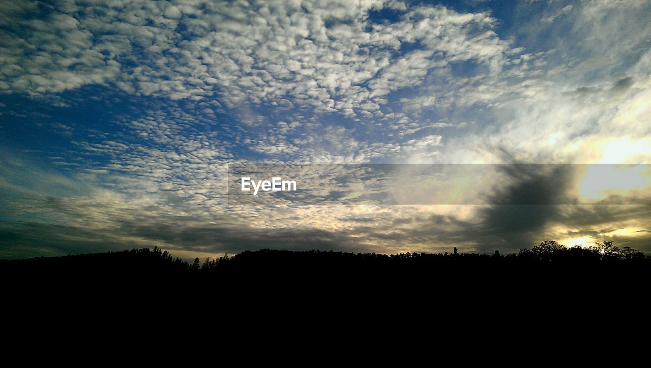 SILHOUETTE OF LANDSCAPE AT SUNSET