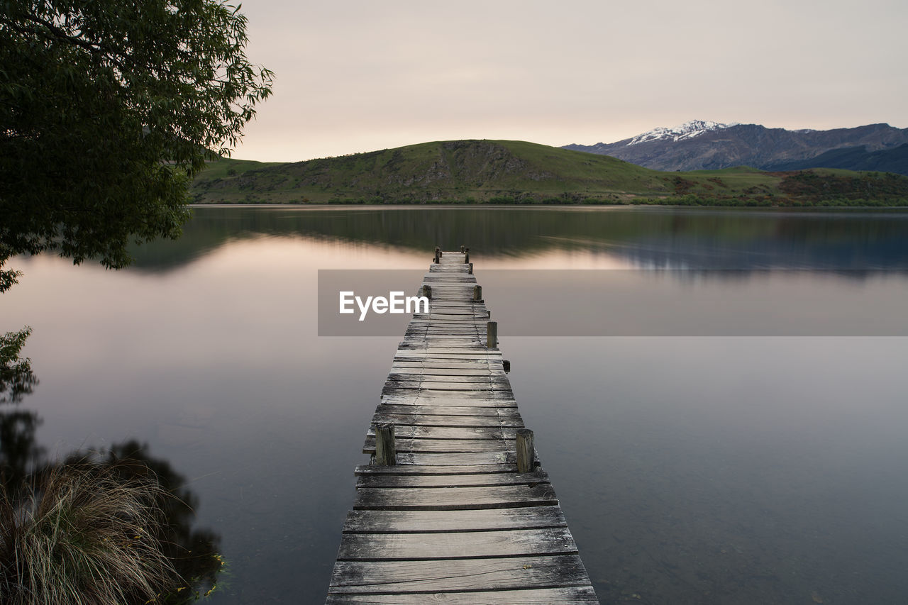 Scenic view of lake against sky at sunset