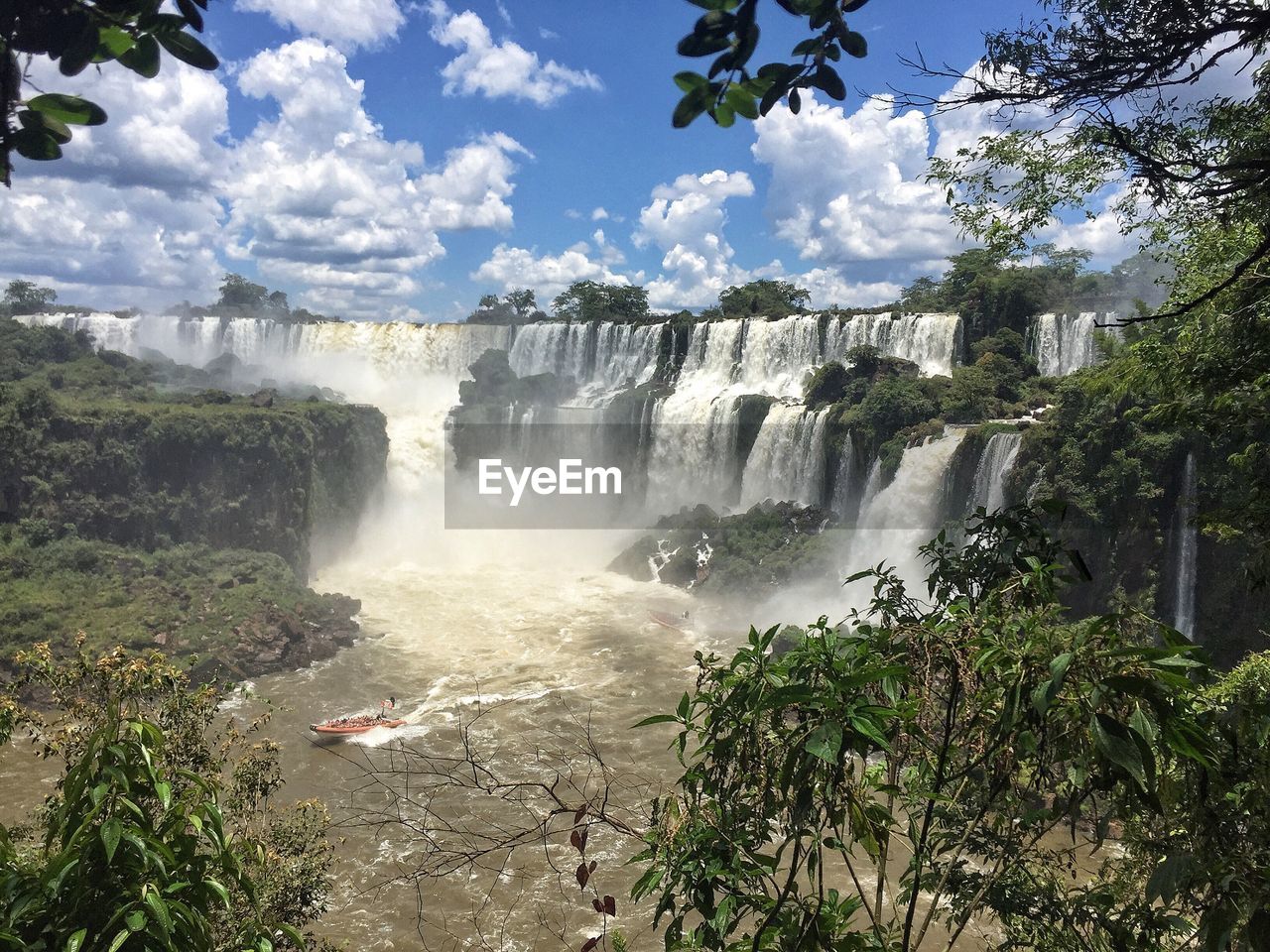 SCENIC VIEW OF WATERFALL AGAINST TREES