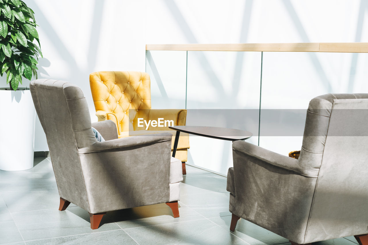 Coffee table with armchairs at open space in the office, interior of coworking