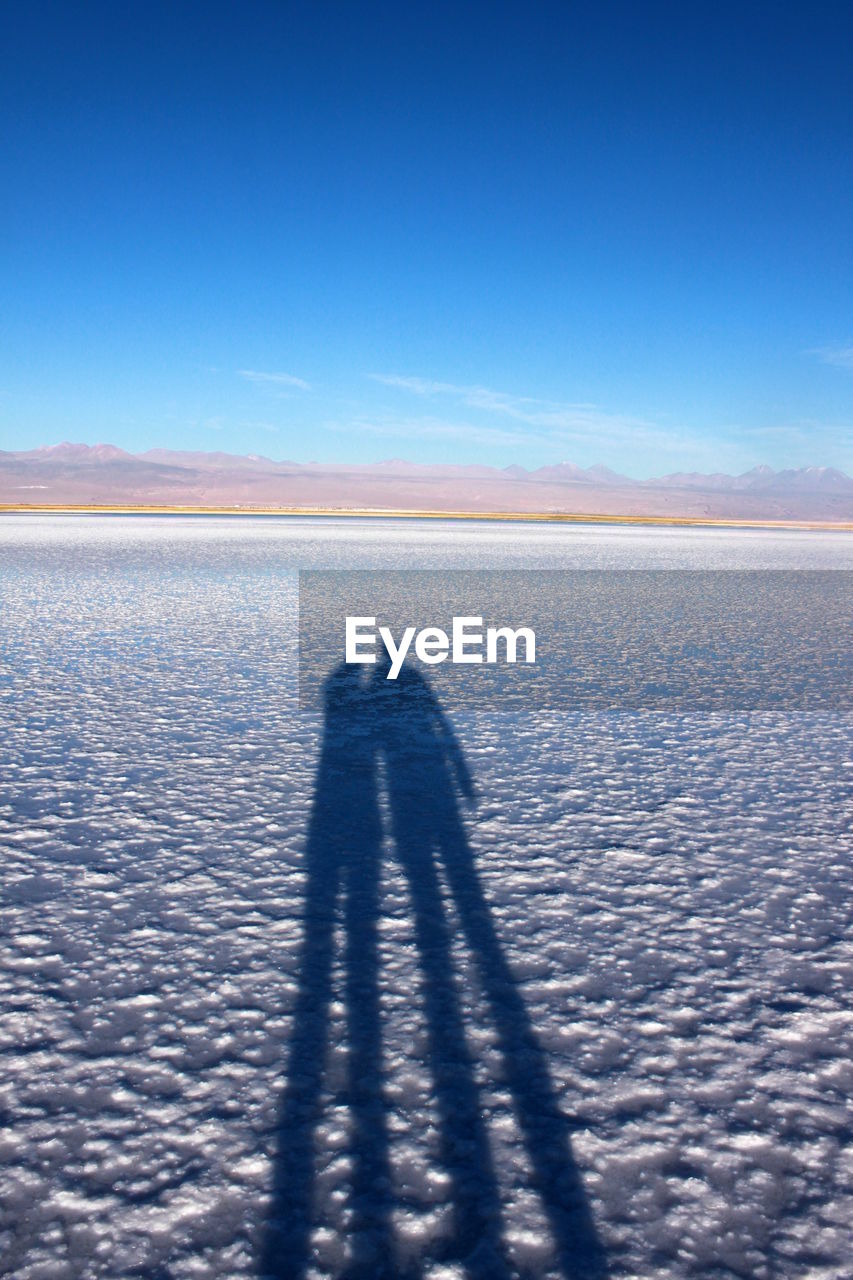 Focus on shadow of couples on salt lake