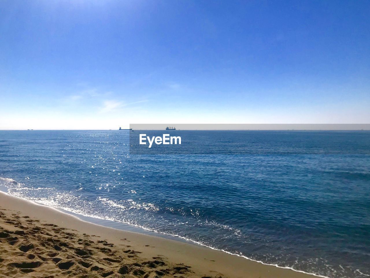 SCENIC VIEW OF BEACH AGAINST CLEAR SKY