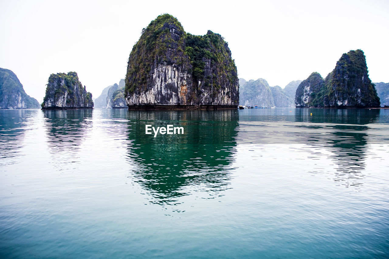 Panoramic view of rocks in sea against clear sky