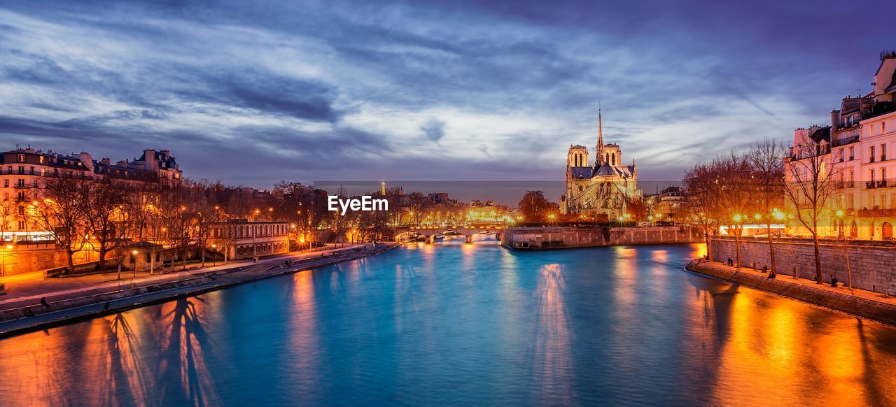 VIEW OF RIVER WITH BUILDINGS IN BACKGROUND