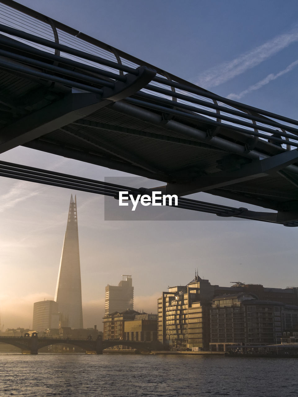 LOW ANGLE VIEW OF BRIDGE OVER RIVER AGAINST SKY