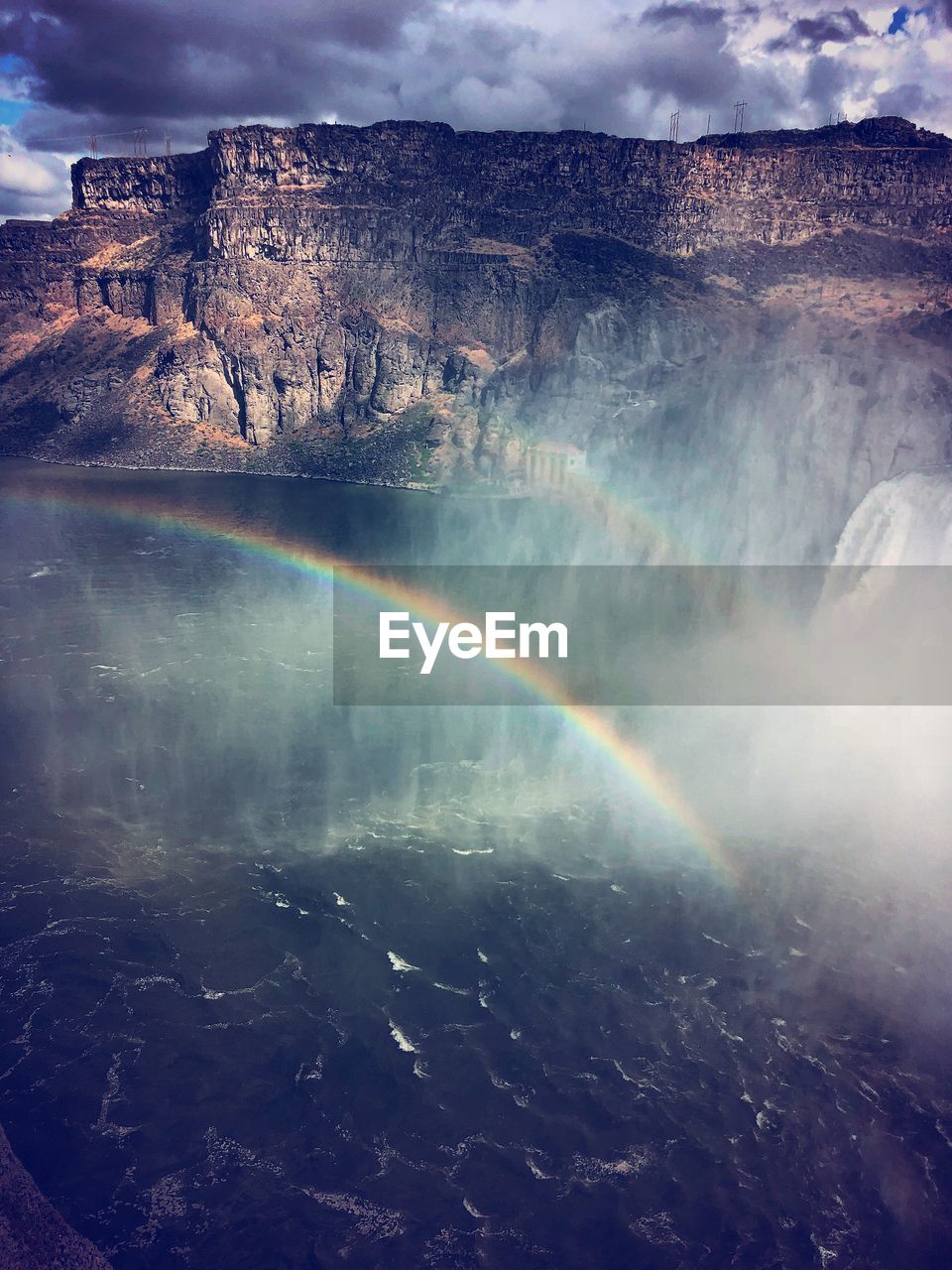 SCENIC VIEW OF RAINBOW OVER MOUNTAINS