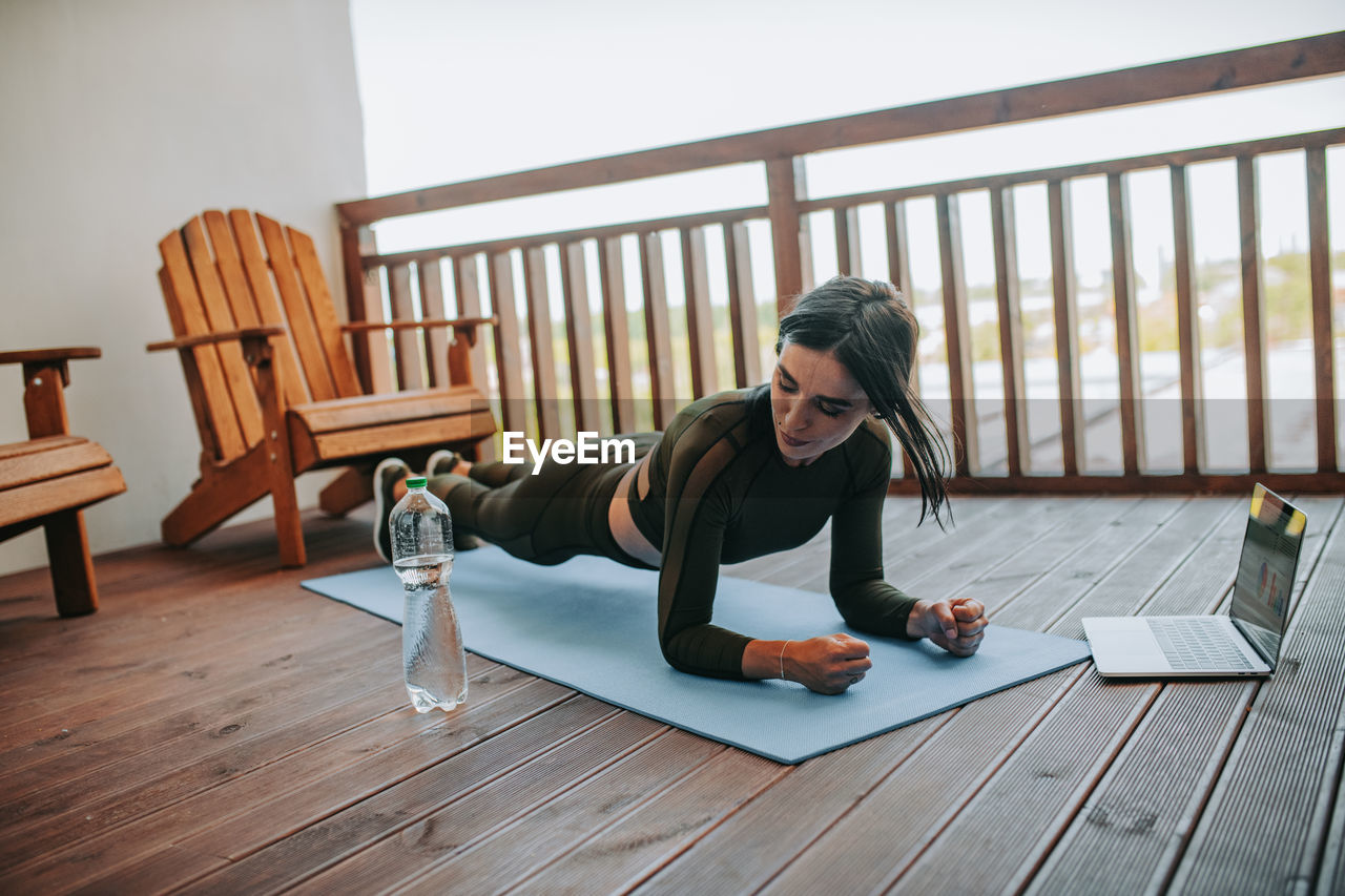 Woman sitting on table at home