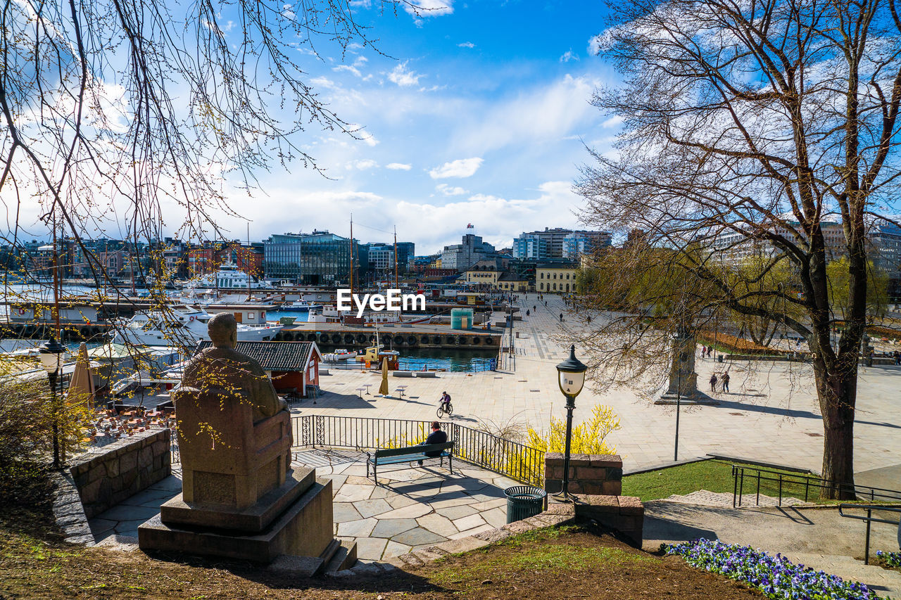 VIEW OF RIVER WITH BUILDINGS IN BACKGROUND