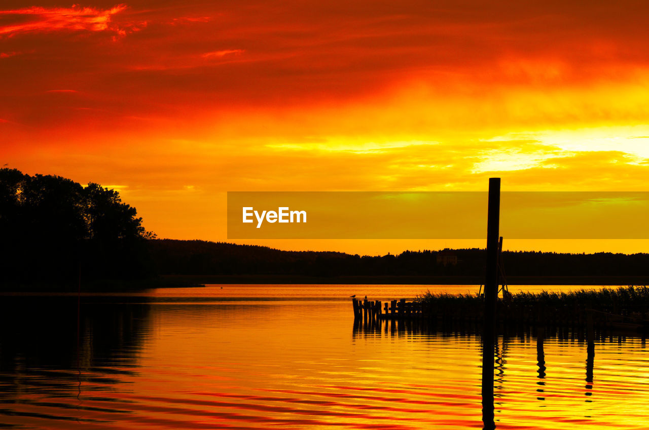 Scenic view of lake at sunset