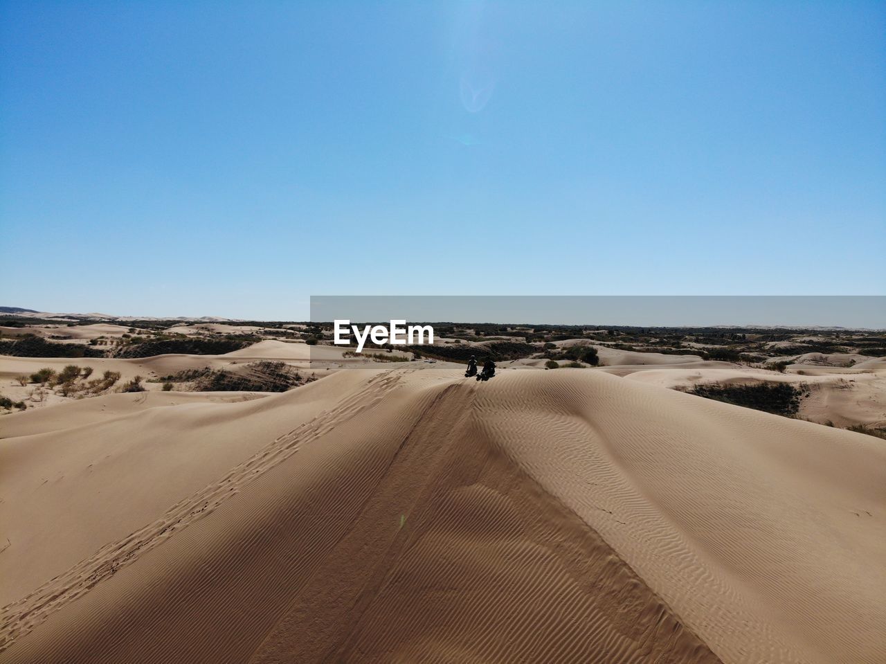 SAND DUNES IN DESERT AGAINST CLEAR SKY