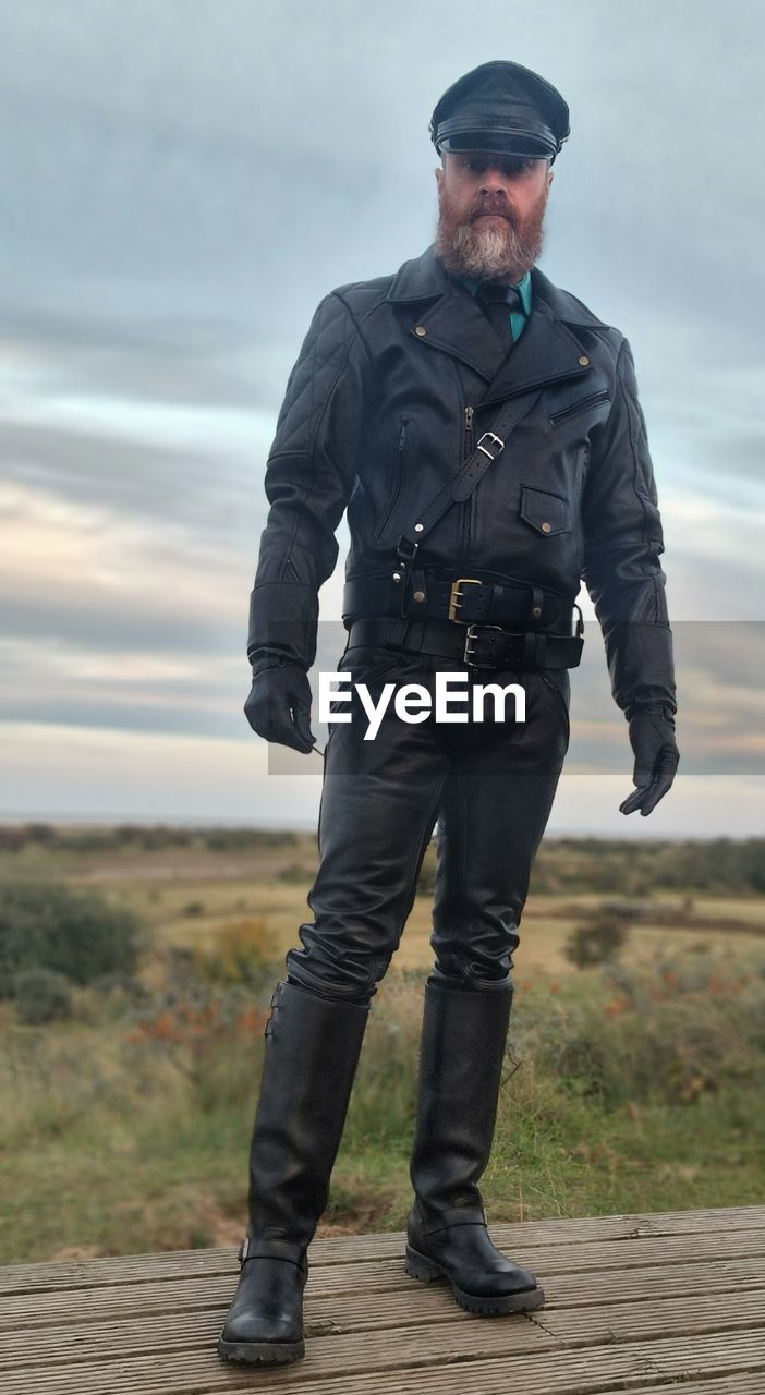 one person, adult, men, clothing, full length, standing, protection, sky, security, cloud, government, front view, person, portrait, authority, nature, mature adult, uniform, occupation, day, serious, outdoors, police force, looking at camera, law, landscape, footwear