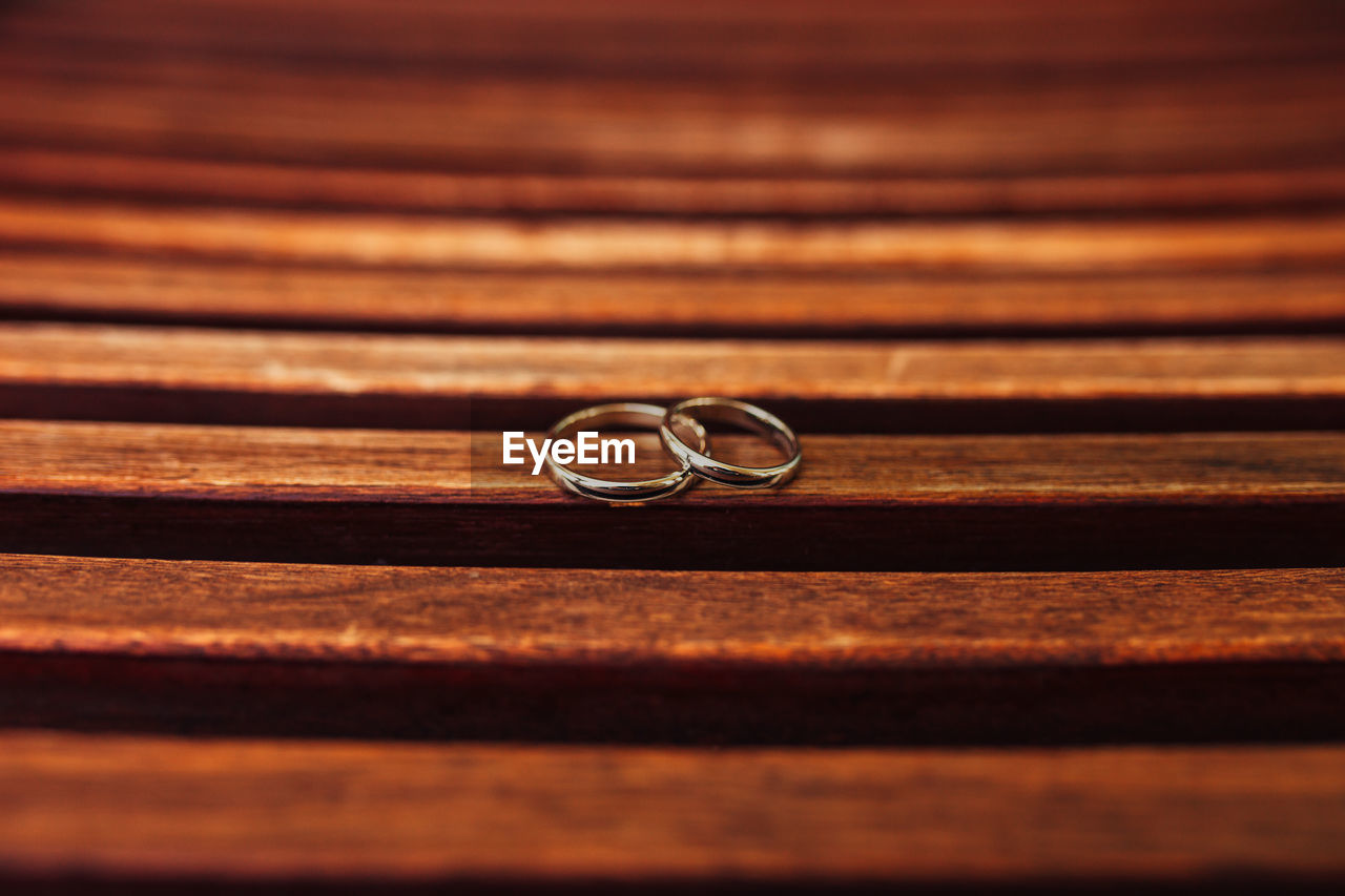 Close-up of wedding rings on table