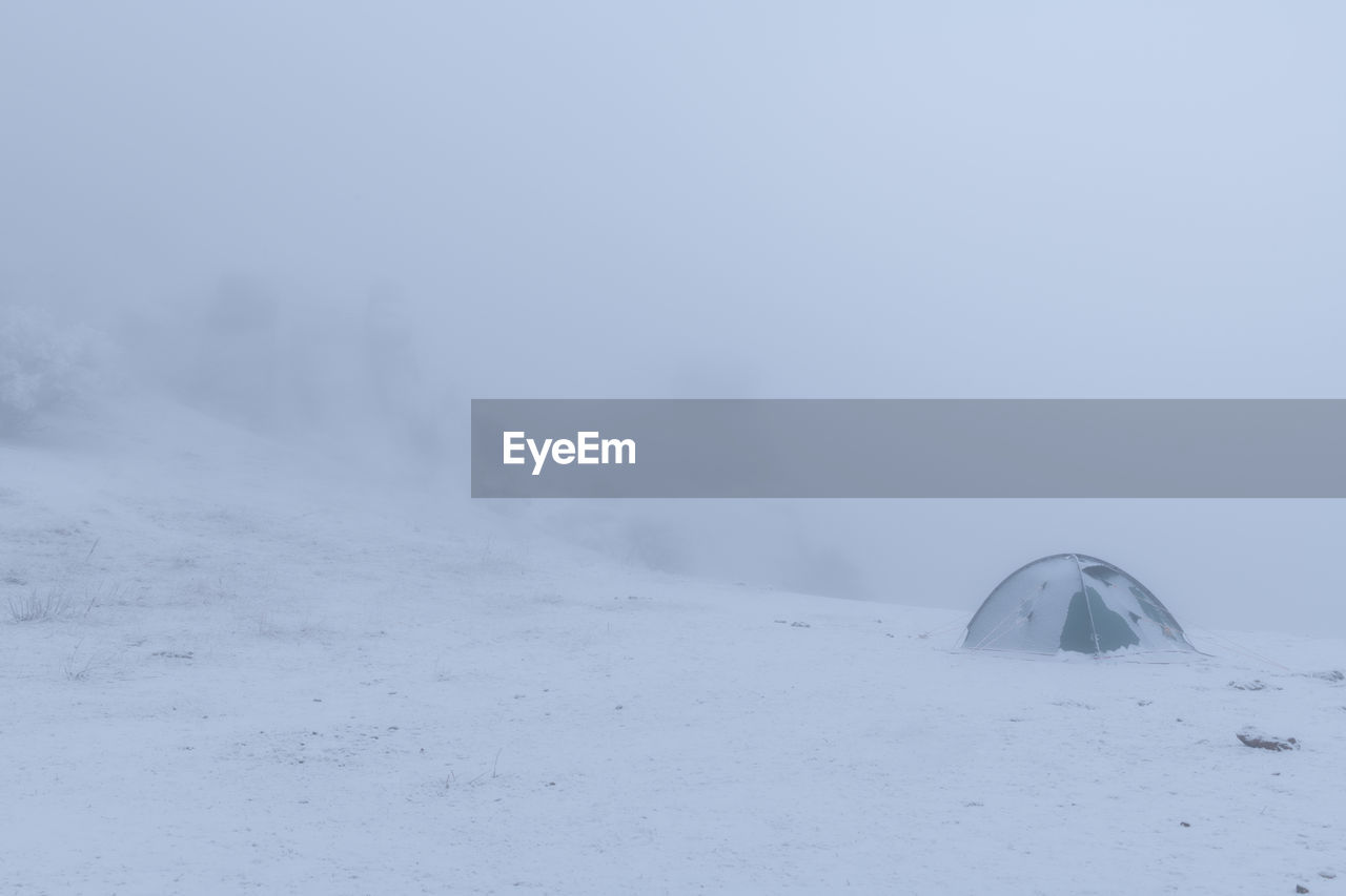 VIEW OF SNOW COVERED LANDSCAPE