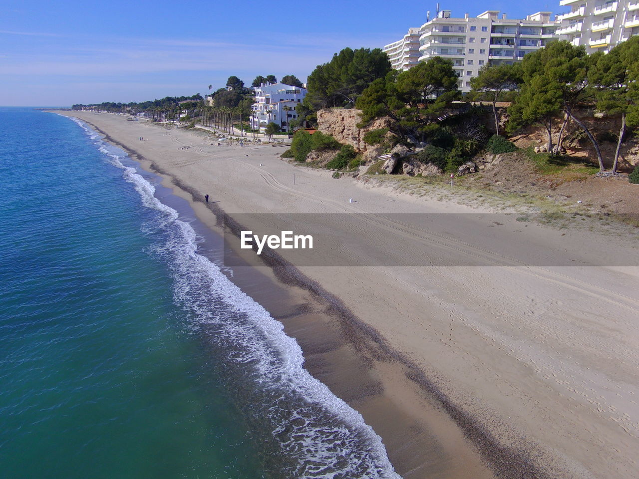 VIEW OF BEACH AGAINST CLEAR BLUE SKY