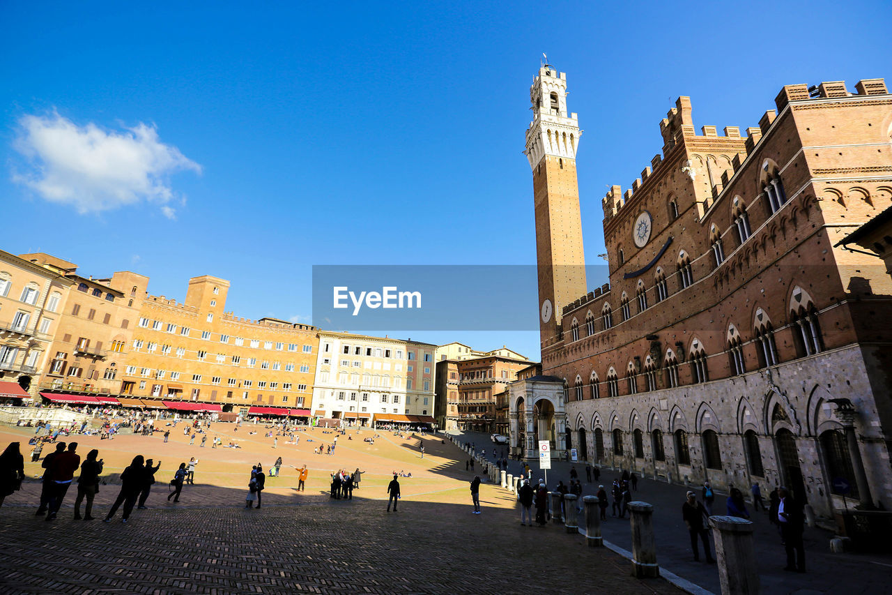 View of buildings in city against blue sky